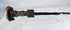 Side view of an ancient Iranian iron sword with a double-edged blade, ribbed handle, and naturally oxidized archaeological surface.