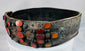 Close-up of orange Cornelian gemstones set into an ornate Jewish bridal belt dating to the 17th–18th century.