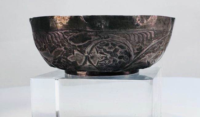 Small Persian silver bowl from the Seljuk period, traditionally associated with storing precious oils, ointments, or perfumes.