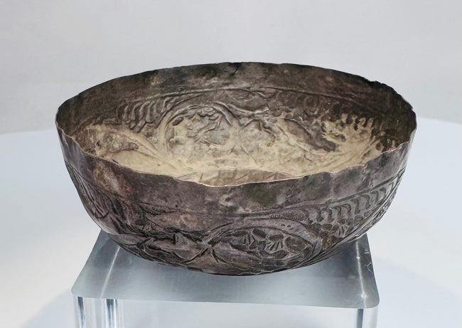 Engraved decoration on a 12th–13th century Seljuk silver bowl showing fine hand-worked patterns and historic surface wear.