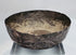 Medieval Persian silver unguent vessel with a shallow rounded form, uneven rim, and centuries-old natural patina.