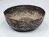 12th–13th century Persian silver bowl showing a compact circular form, aged interior surface, and slightly irregular hand-forged rim.