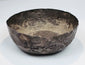 12th–13th century Persian silver bowl showing a compact circular form, aged interior surface, and slightly irregular hand-forged rim.