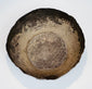 Interior of a Seljuk silver bowl showing natural oxidation, surface wear, and preserved hand-forged construction.