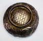 Medieval Islamic metalwork bowl from Persia with delicate engraved ornamentation reflecting Seljuk artistic craftsmanship.