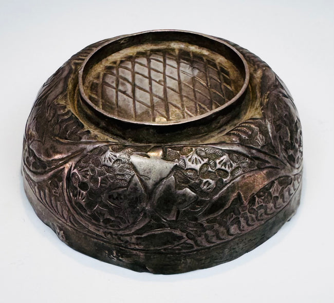 Seljuk-period silver unguent bowl displaying engraved decoration, aged silver surfaces, and a compact 2.5-inch diameter form.