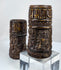 Antique Tibetan ritual prayer wheels fashioned from human femur bone and decorated with symbolic Buddhist devotional imagery.