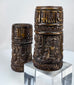 Antique Tibetan ritual prayer wheels fashioned from human femur bone and decorated with symbolic Buddhist devotional imagery.