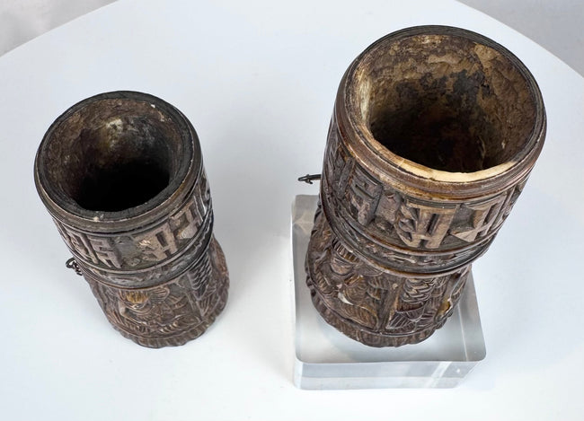 Pair of hand-carved Tibetan bone prayer wheels with preserved relief decoration and natural age-related patina.