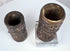 Pair of hand-carved Tibetan bone prayer wheels with preserved relief decoration and natural age-related patina.