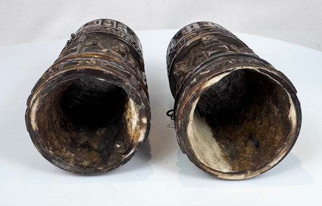 Relief-carved Buddhist figures and sacred inscriptions preserved on 18th–19th century Tibetan human bone prayer wheels.