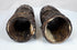 Relief-carved Buddhist figures and sacred inscriptions preserved on 18th–19th century Tibetan human bone prayer wheels.