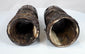 Relief-carved Buddhist figures and sacred inscriptions preserved on 18th–19th century Tibetan human bone prayer wheels.