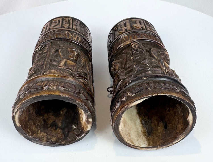 Historic Tibetan Buddhist prayer wheels made from human femur bone, combining ritual function with intricate hand-carved decoration.