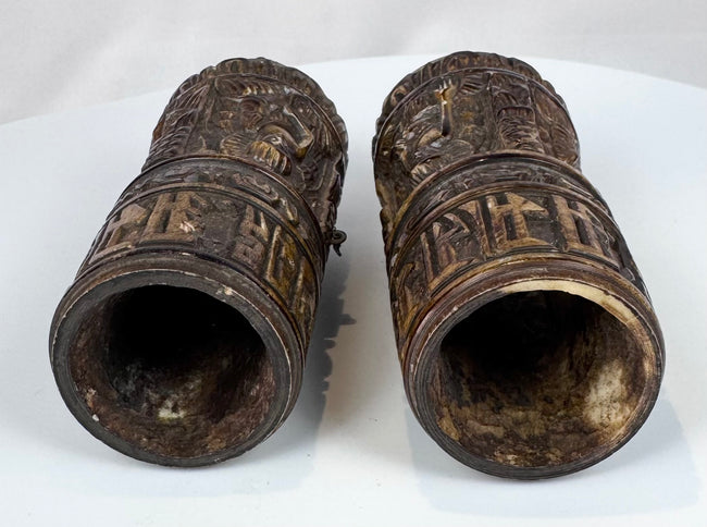 Rare pair of Tibetan Buddhist human bone prayer wheels with carved Buddha figures, sacred inscriptions, and centuries-old surface wear.