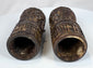 Rare pair of Tibetan Buddhist human bone prayer wheels with carved Buddha figures, sacred inscriptions, and centuries-old surface wear.