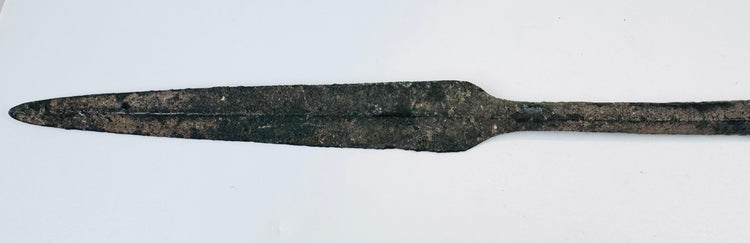Ancient bronze spearhead from Cyprus featuring a tapered blade, reinforced four-sided midsection, preserved tang, and naturally oxidized surface from the Early Cypriot III period.