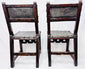 Antique leather-upholstered chairs with dark walnut frames and metal studs
