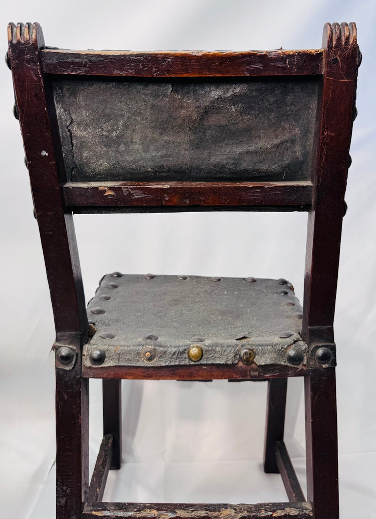 Detail of aged leather upholstery and domed studs on Spanish Baroque chair