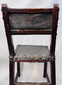Detail of aged leather upholstery and domed studs on Spanish Baroque chair