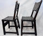 Side view of an antique Spanish walnut chair with leather seat and back