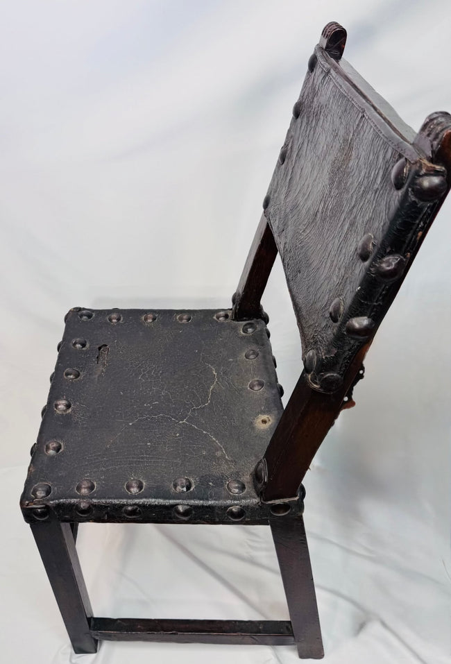 Close-up of carved crest-like terminals on a Spanish walnut chair