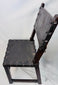 Close-up of carved crest-like terminals on a Spanish walnut chair