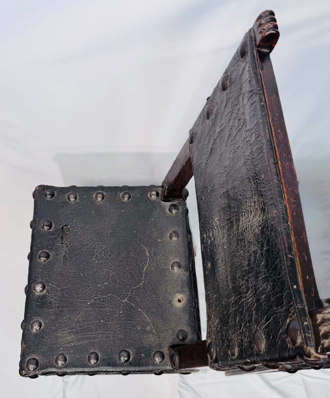 Historic Spanish chairs with naturally patinated leather and dark wood frames