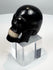 Front view of a carved horn memento mori skull with articulated teeth