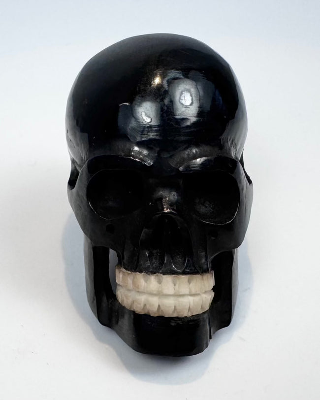 Miniature polished black horn skull carving, circa 1880–1950