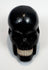 Detailed view of the contrasting tooth-like inserts in the carved skull