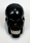 Detailed view of the contrasting tooth-like inserts in the carved skull