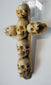 Small Christian vanitas cross decorated with six hand-carved human skulls
