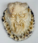 Hand-carved deer antler plaque depicting a fierce Japanese oni