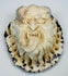 Compact Japanese antler oni plaque with retained dark outer cortex