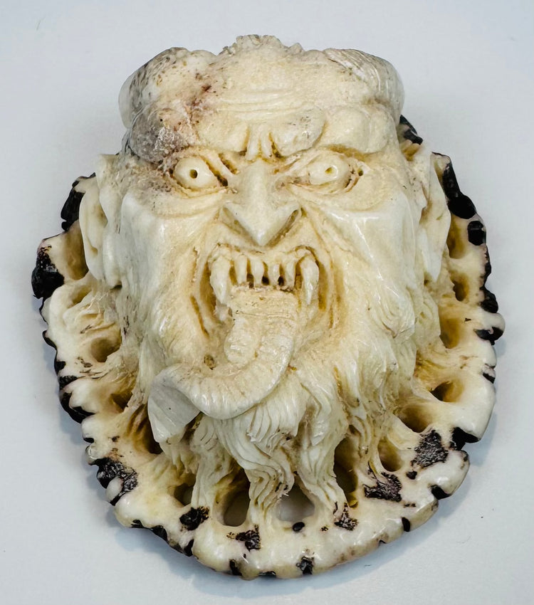 Compact Japanese antler oni plaque with retained dark outer cortex