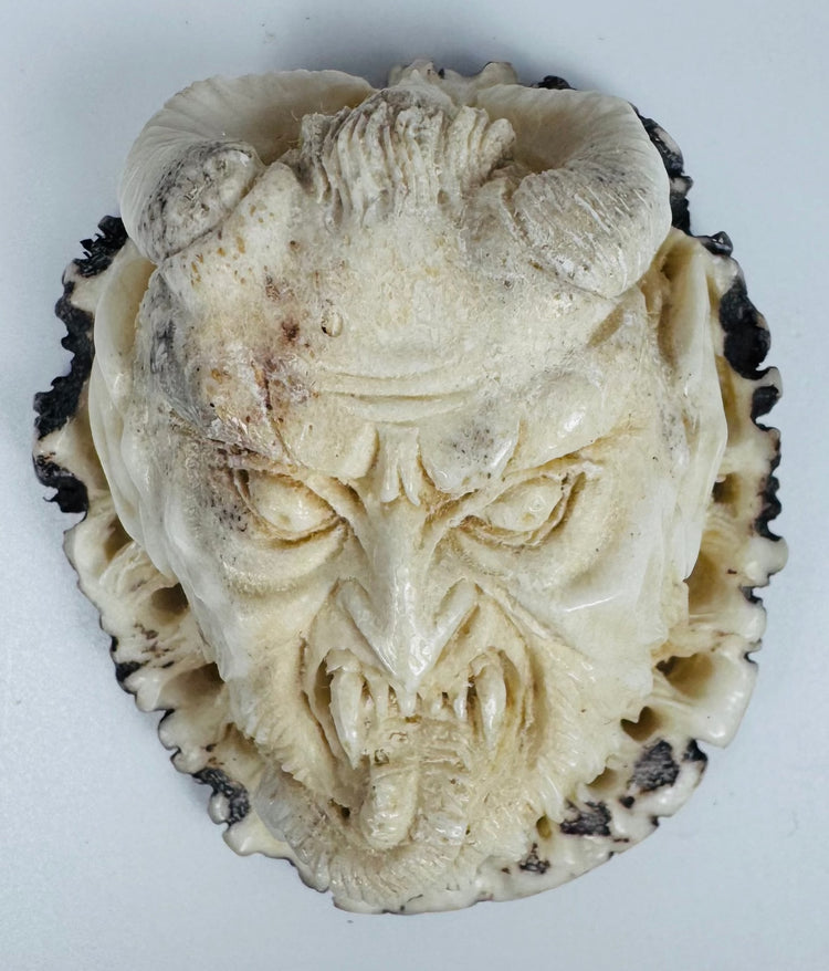 Antique Meiji-era style stag antler carving of a horned demon