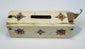 Side view of antique bone domino box with hand-worked decoration