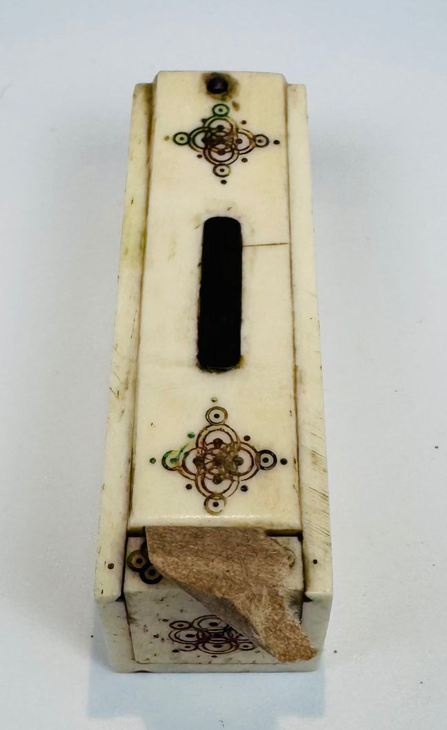 Historic miniature bone domino game displayed with its fitted case