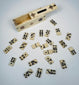 Open sliding-lid case containing miniature 19th-century bone dominoes