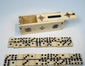 Miniature antique domino set arranged beside its decorated bone box