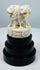 Pale bone-like Ashoka lion sculpture mounted on an ebonized pedestal