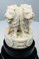 Carved Ashoka lions with dharmachakra motifs on a tiered black base