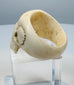 Reverse of a hand-carved skull ring revealing the continuous bone band
