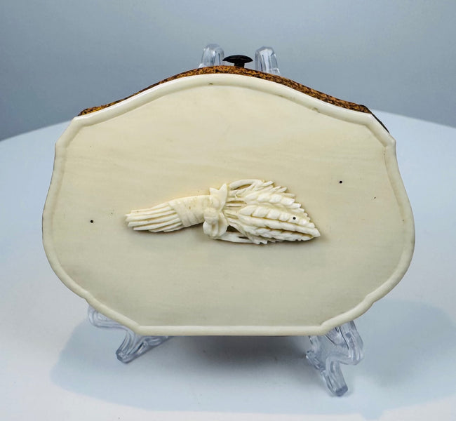 Antique bone change purse with brown leather accordion sides and carved grain decoration