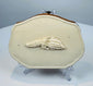Antique bone change purse with brown leather accordion sides and carved grain decoration