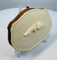 Detailed hand-carved wheat and grain ornament on an antique bovine bone purse