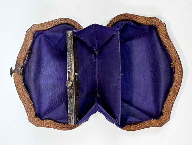 Interior view of Victorian change purse with multiple silk compartments and metal frame