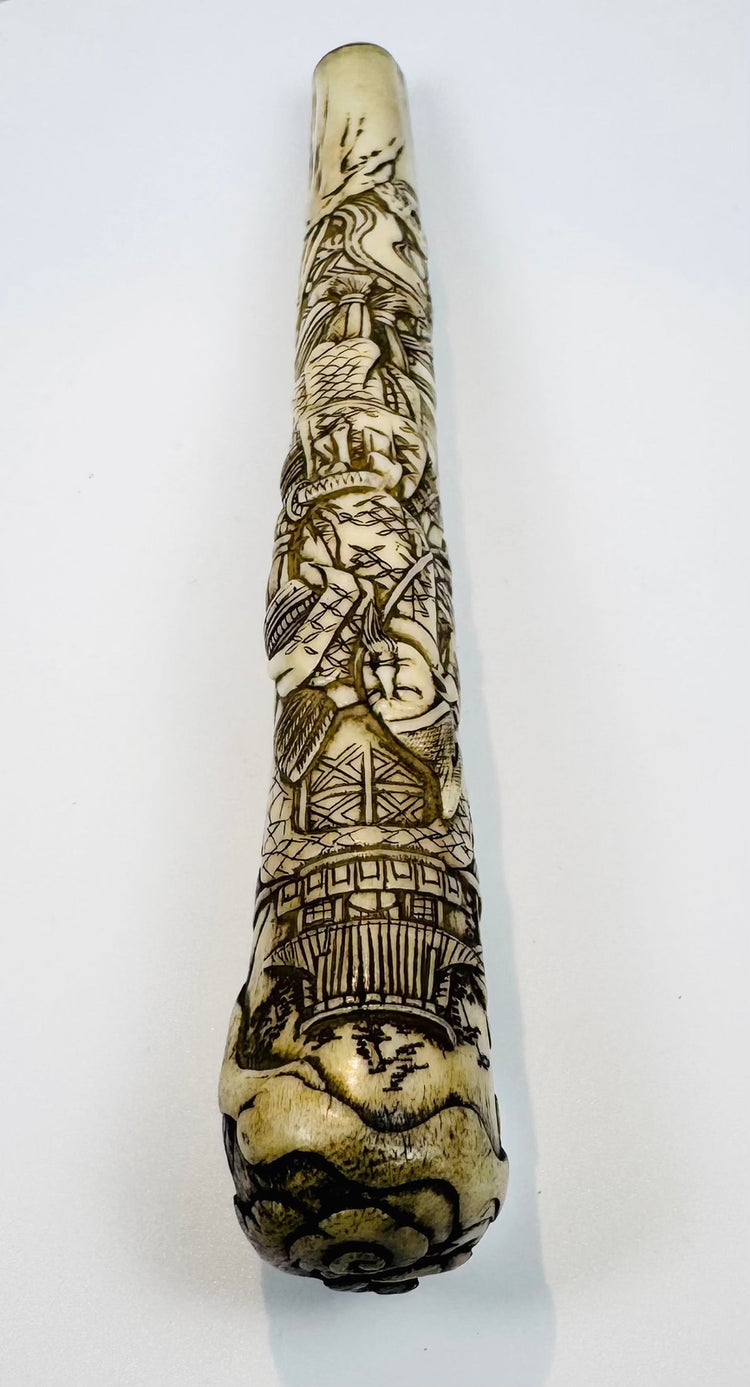 Close-up of samurai warrior in armour carved into an antique Japanese bone handle
