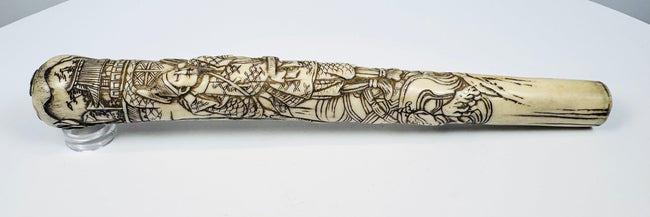 Antique Japanese bone fitting carved with a samurai warrior and landscape scene